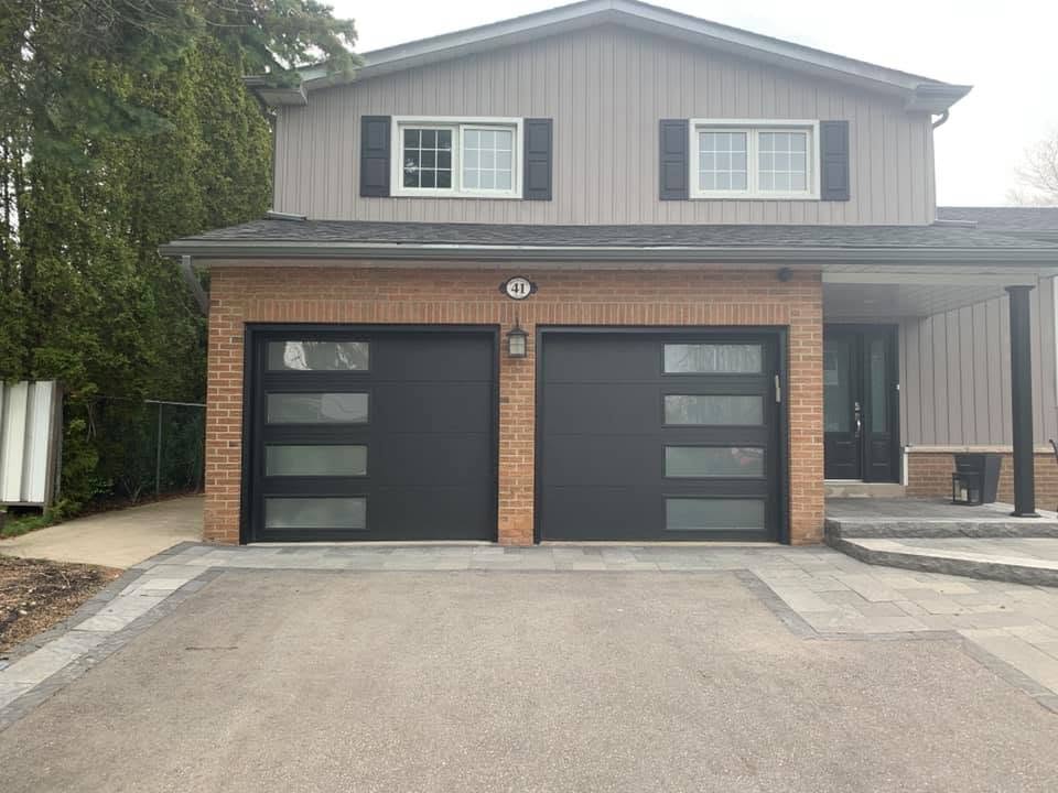 Finished black residential garage door installed by Kinnaird Garage Doors